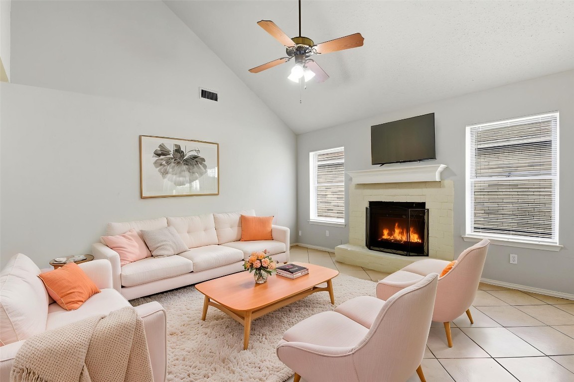 22910 Sherioaks Lane Spring, TX 77389 - Photo 3 of 27 a living room with furniture a fireplace and a flat screen tv