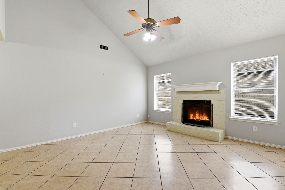 22910 Sherioaks Lane Spring, TX 77389 - Photo 4 of 27 an empty room with fireplace and fan