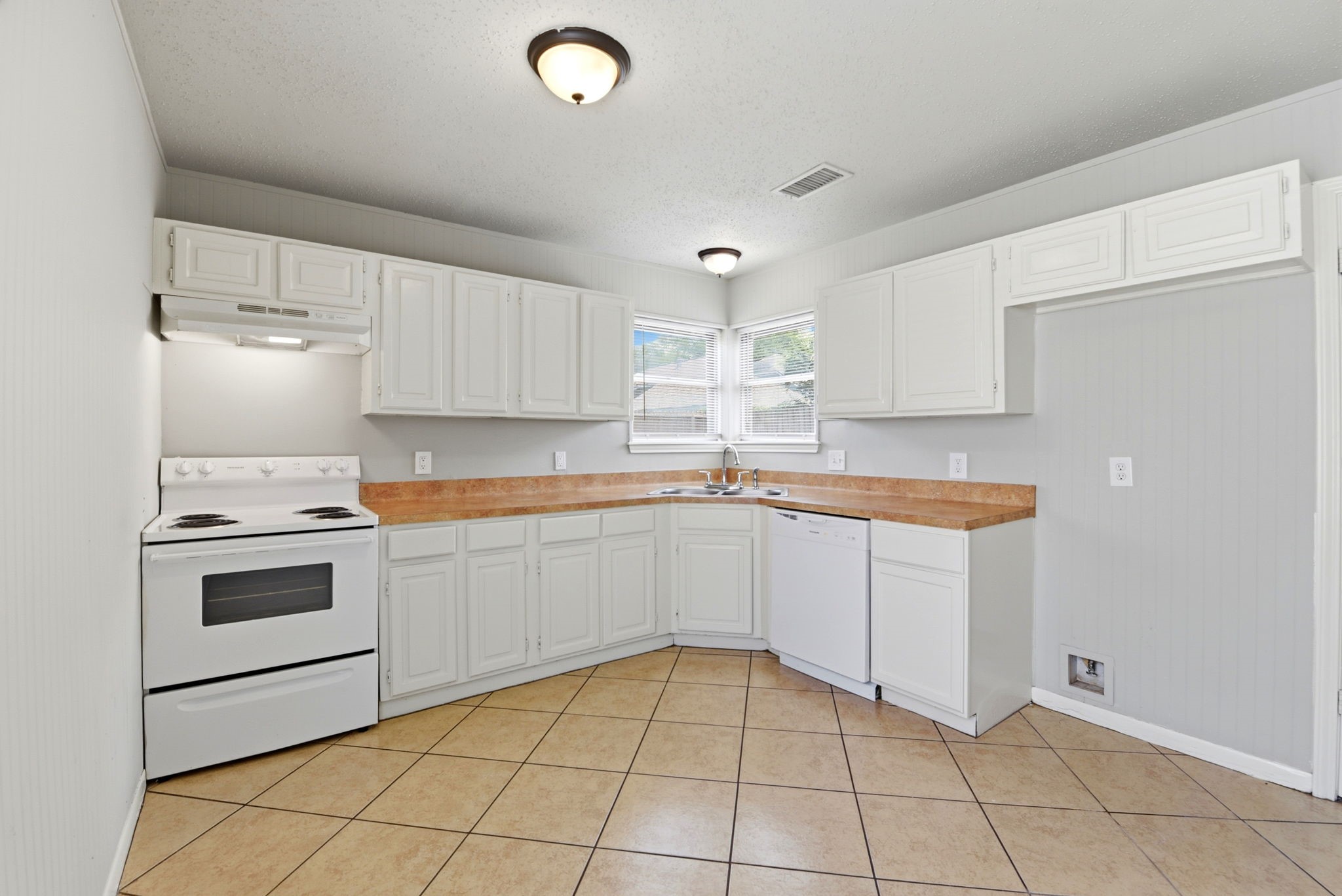 22910 Sherioaks Lane Spring, TX 77389 - Photo 8 of 27 a kitchen with a stove sink and cabinets