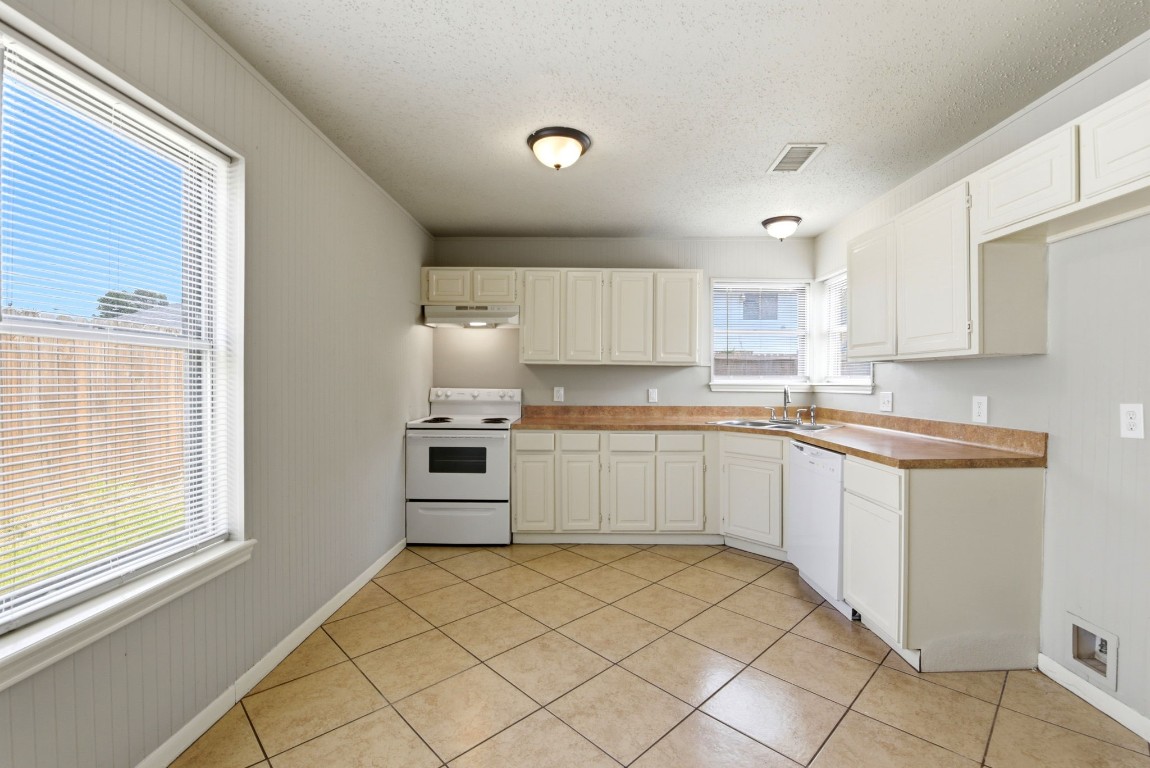 22910 Sherioaks Lane Spring, TX 77389 - Photo 9 of 27 a kitchen with a sink window and cabinets