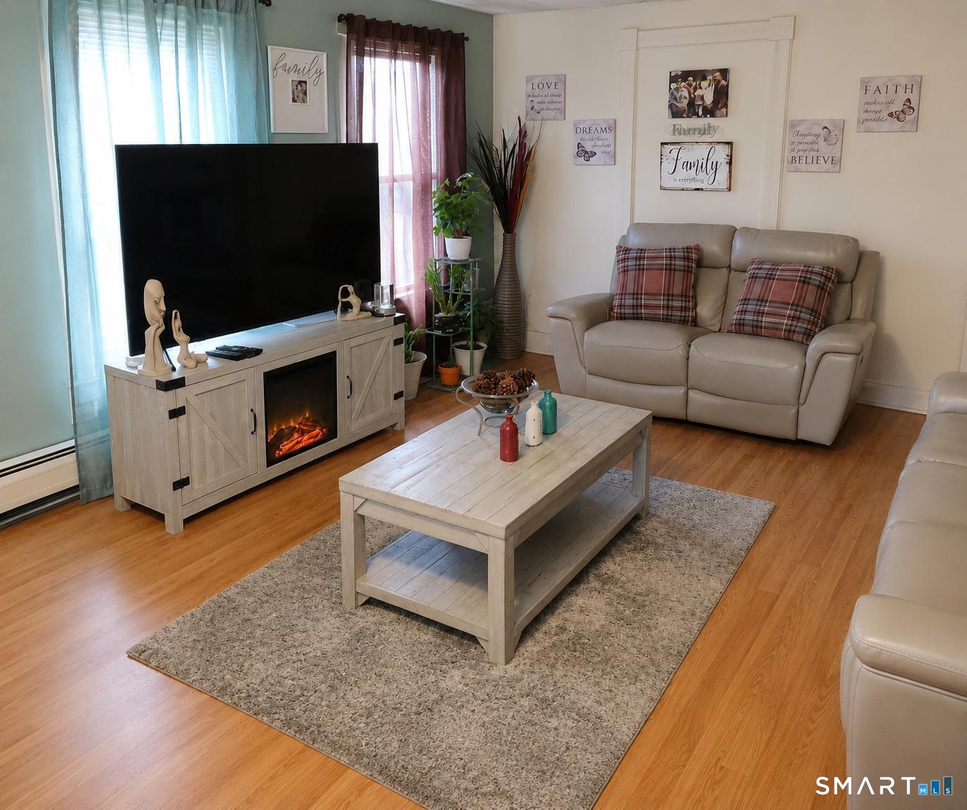 61 Bartlett Street Meriden, CT 06451 - Photo 23 of 30 a living room with furniture and a flat screen tv