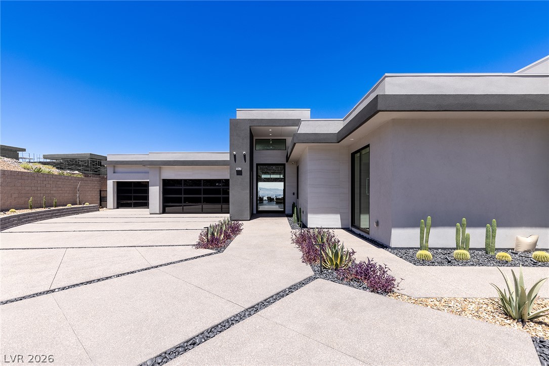 563 Grand Rim Drive Henderson, NV 89012 - Photo 67 of 70 Clean lines and a modern facade welcome you home with drought-tolerant landscaping and a spacious driveway.
