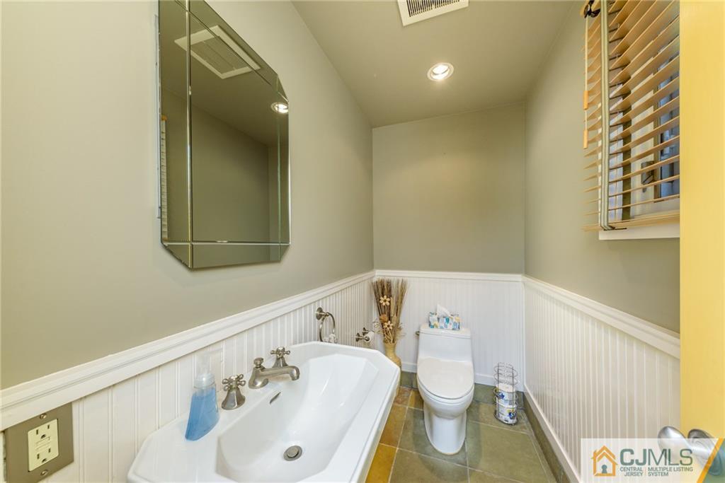24 East Cliff Road Colonia, NJ 07067 - Photo 16 of 46 a bathroom with a sink and a mirror
