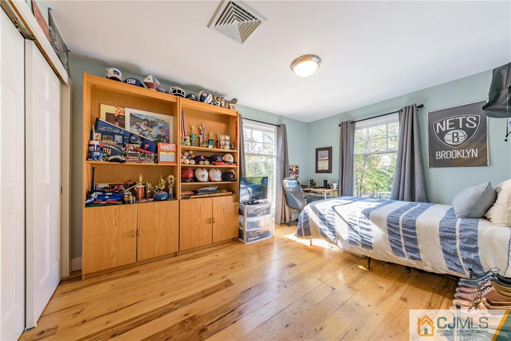 24 East Cliff Road Colonia, NJ 07067 - Photo 17 of 46 a bed room with a bed and a large window