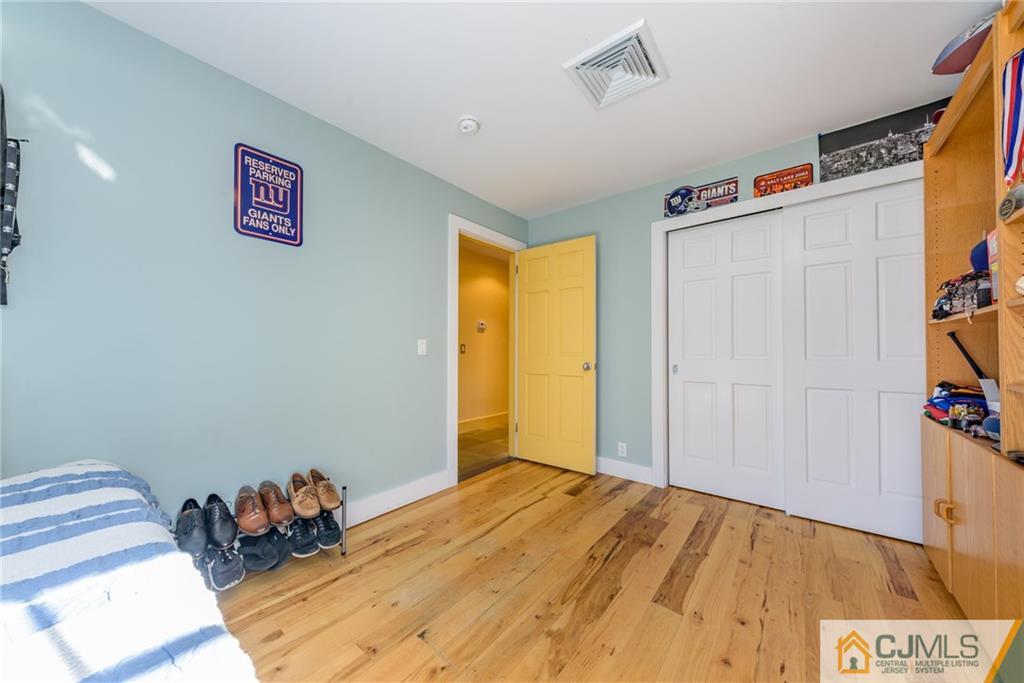 24 East Cliff Road Colonia, NJ 07067 - Photo 18 of 46 a bedroom with a bed and a dresser