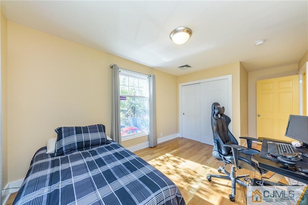 24 East Cliff Road Colonia, NJ 07067 - Photo 20 of 46 a bedroom with a bed and wooden floor