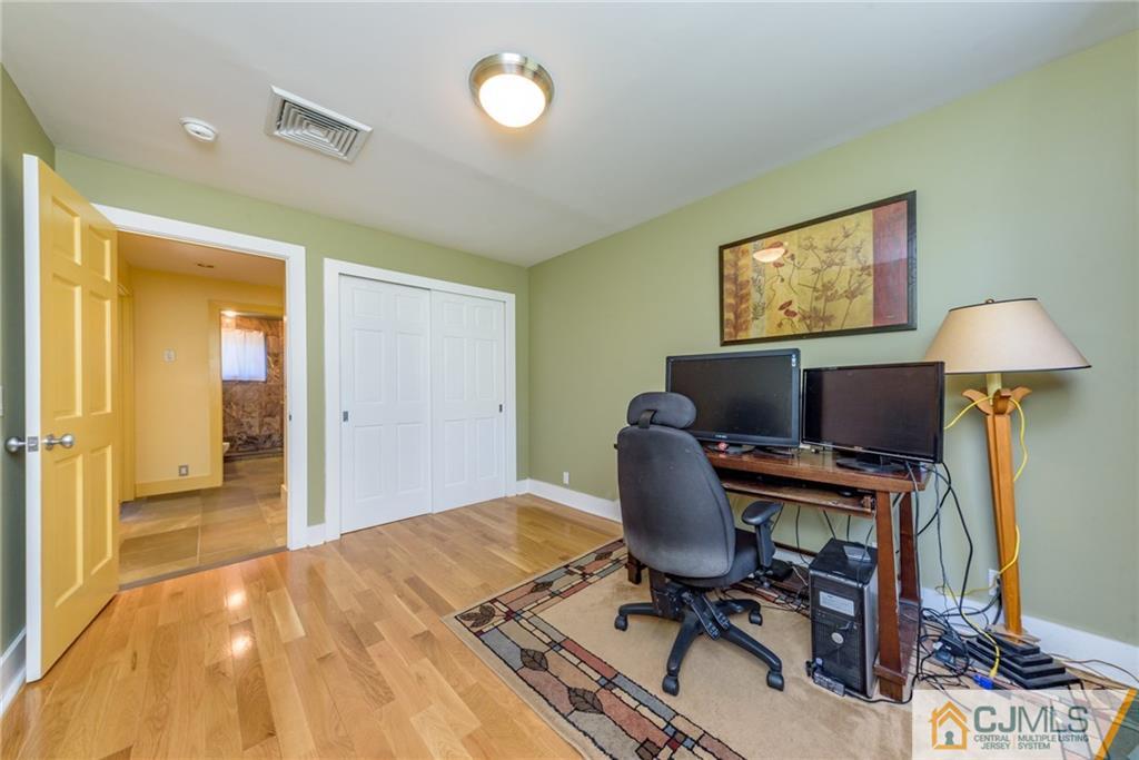 24 East Cliff Road Colonia, NJ 07067 - Photo 21 of 46 a workspace with furniture and a flat screen tv