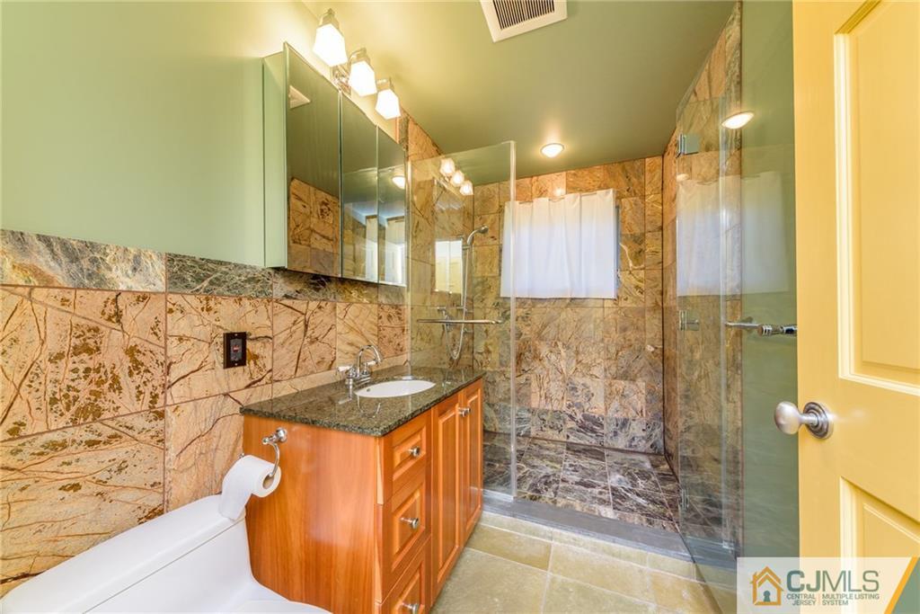 24 East Cliff Road Colonia, NJ 07067 - Photo 23 of 46 a bathroom with a sink and a mirror