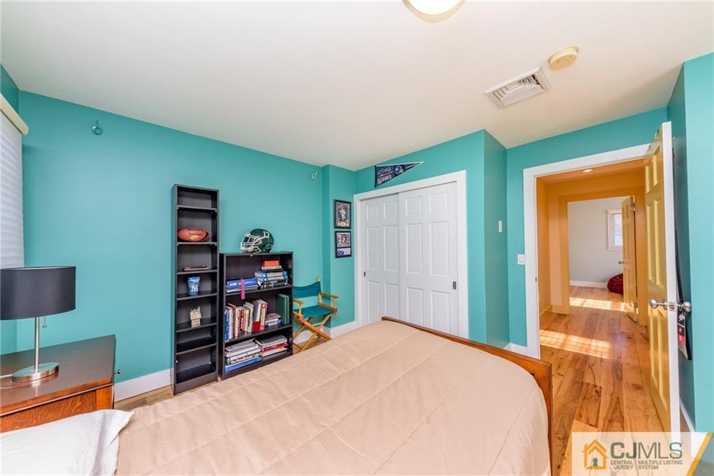24 East Cliff Road Colonia, NJ 07067 - Photo 25 of 46 a bedroom with a bed and a bookshelf