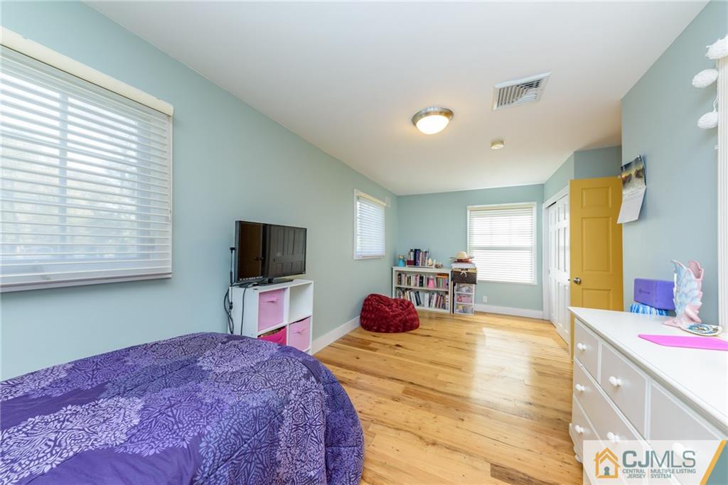 24 East Cliff Road Colonia, NJ 07067 - Photo 27 of 46 a bedroom with a bed and a flat screen tv
