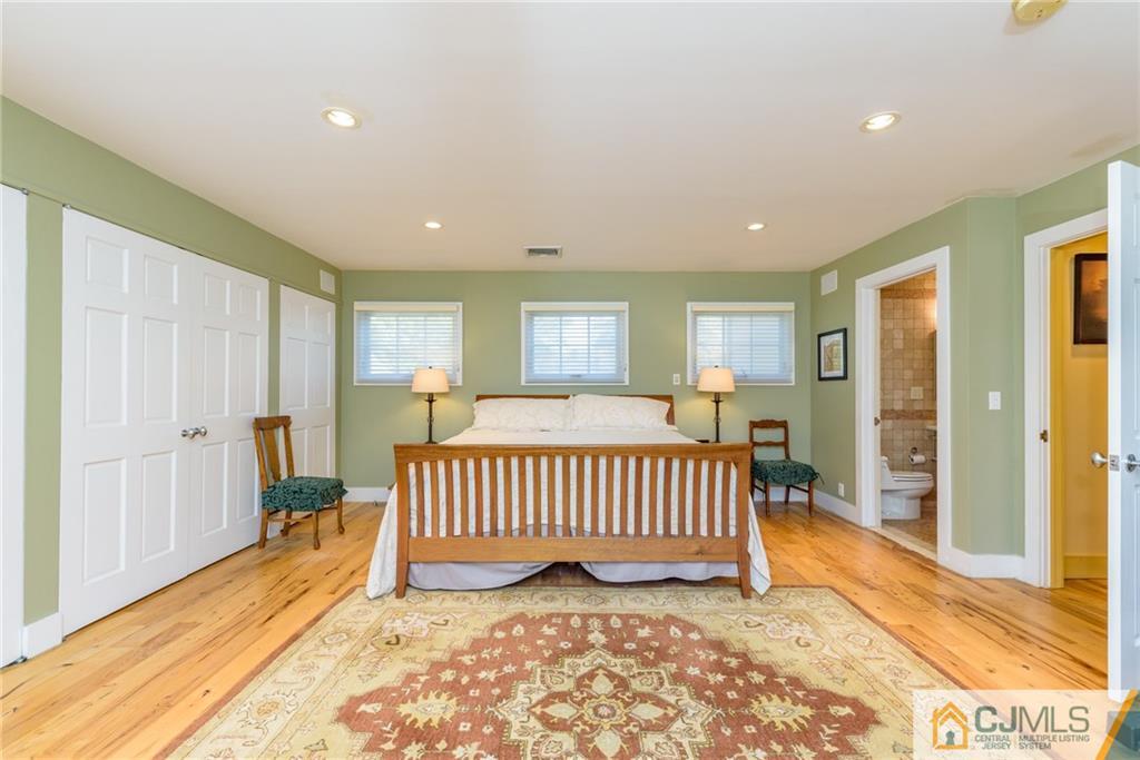 24 East Cliff Road Colonia, NJ 07067 - Photo 29 of 46 a view of a bedroom with a bed and wooden floor