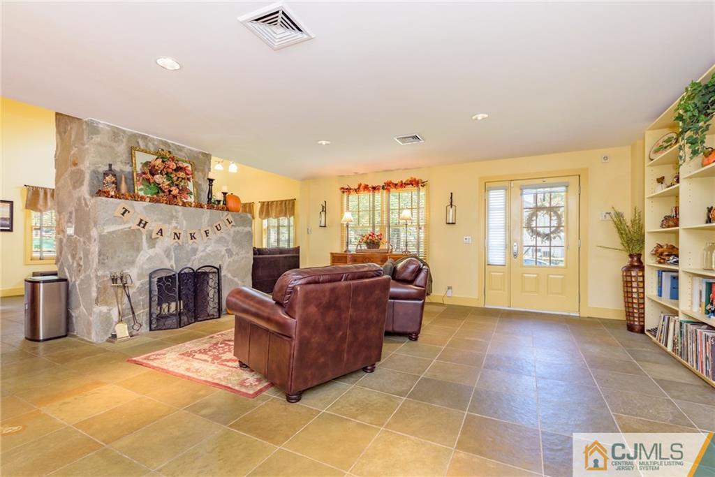 24 East Cliff Road Colonia, NJ 07067 - Photo 4 of 46 a living room with furniture a fireplace and a large window