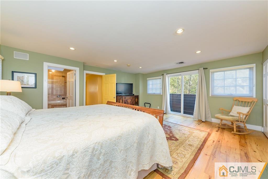 24 East Cliff Road Colonia, NJ 07067 - Photo 31 of 46 a bed room with a bed and large windows