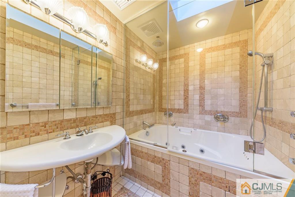 24 East Cliff Road Colonia, NJ 07067 - Photo 32 of 46 a bathroom with a bathtub and a sink
