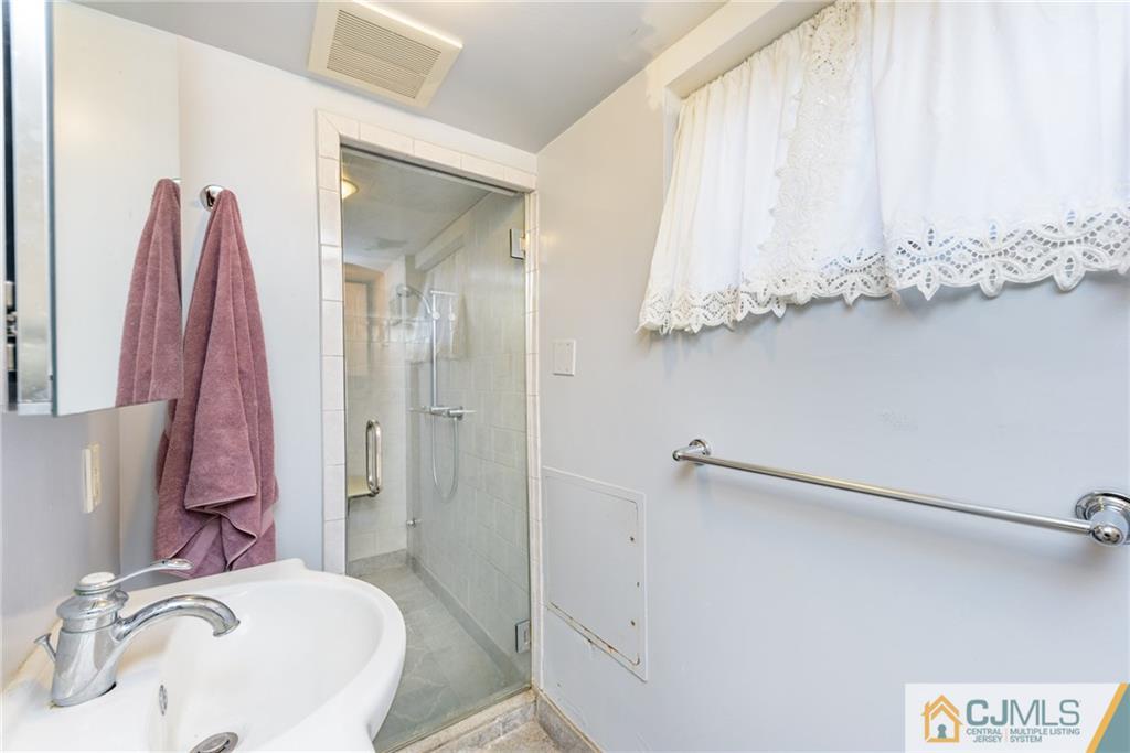 24 East Cliff Road Colonia, NJ 07067 - Photo 36 of 46 a bathroom with a sink and a mirror