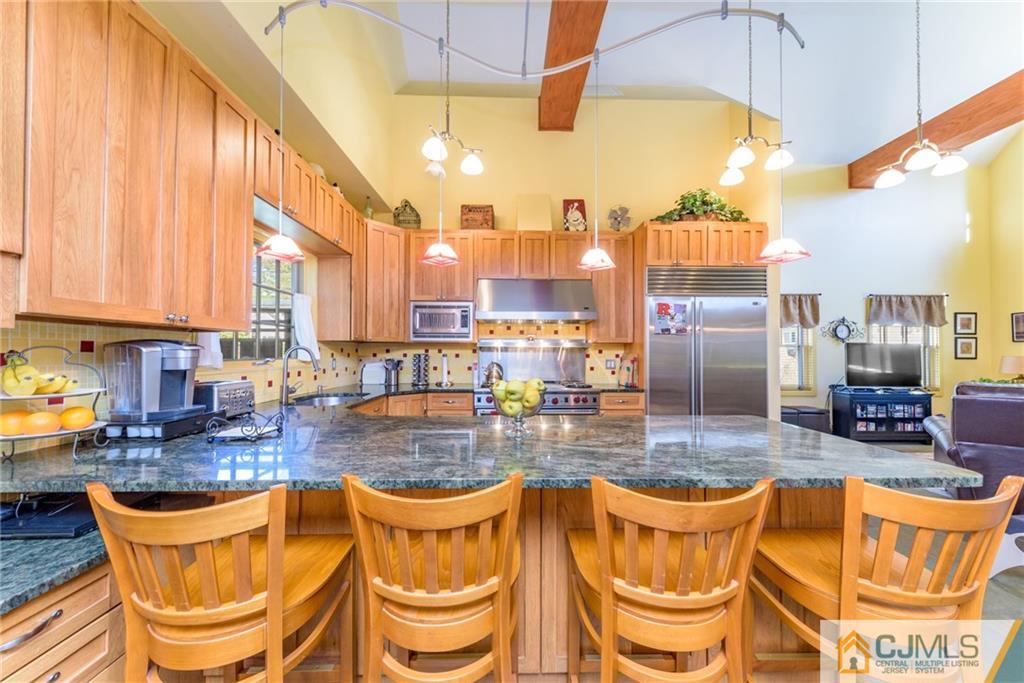 24 East Cliff Road Colonia, NJ 07067 - Photo 8 of 46 a kitchen with stainless steel appliances granite countertop a granite counter tops and a view of living room