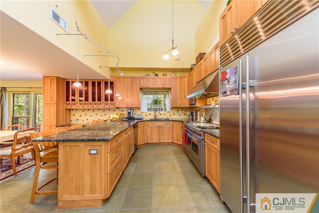 24 East Cliff Road Colonia, NJ 07067 - Photo 9 of 46 a large kitchen with stainless steel appliances granite countertop lots of counter top space and windows
