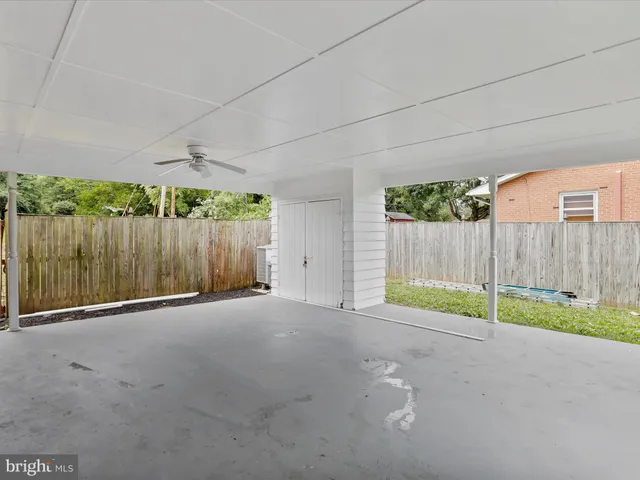 a view of backyard with wooden fence