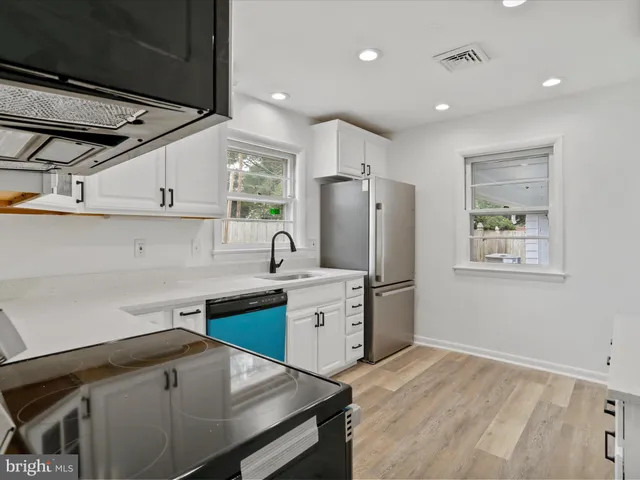 a kitchen with a sink appliances and cabinets