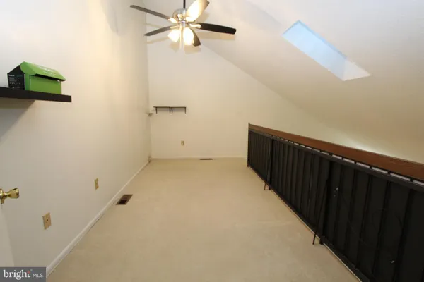 a view of a hallway with a ceiling fan