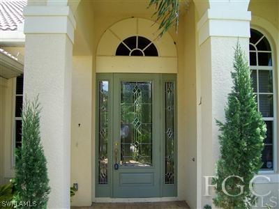 11620 Compass Point Drive Fort Myers, FL 33908 - Photo 2 of 10 a front view of a house with a yard