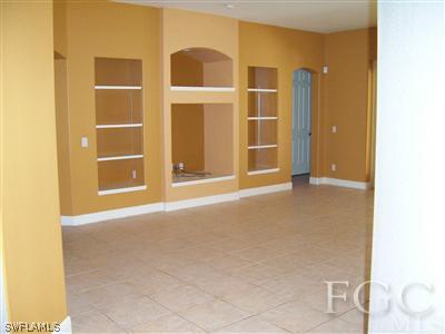 11620 Compass Point Drive Fort Myers, FL 33908 - Photo 6 of 10 a view of an empty room with wooden floor and a bathroom