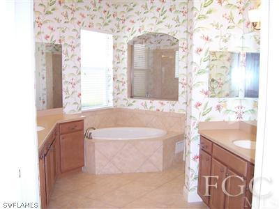 11620 Compass Point Drive Fort Myers, FL 33908 - Photo 7 of 10 a bathroom with a bathtub sink and mirror