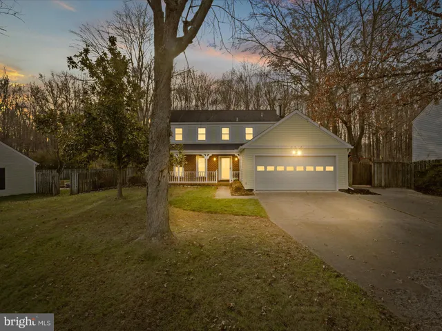 a view of a large tree in front of a house