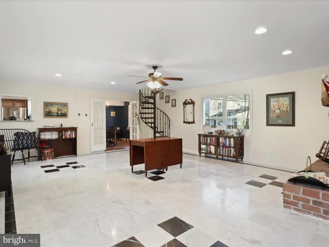 a living room with furniture gym equipment and a flat screen tv