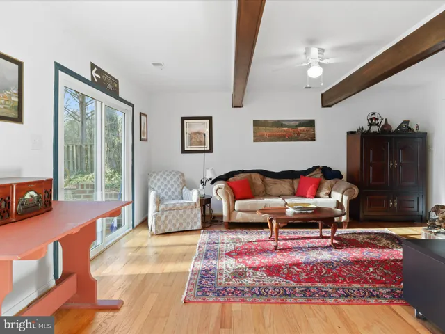 a living room with furniture rug and window
