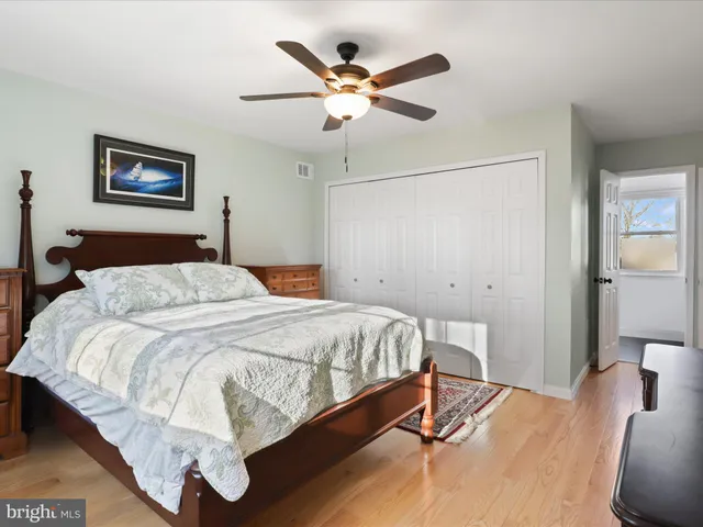 a bedroom with a bed and ceiling fan