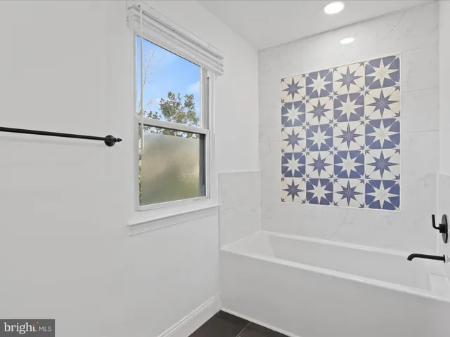 a bathroom with a bathtub and shower