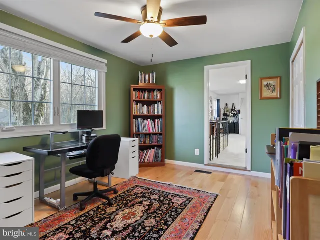 a view of a workspace with furniture and a window