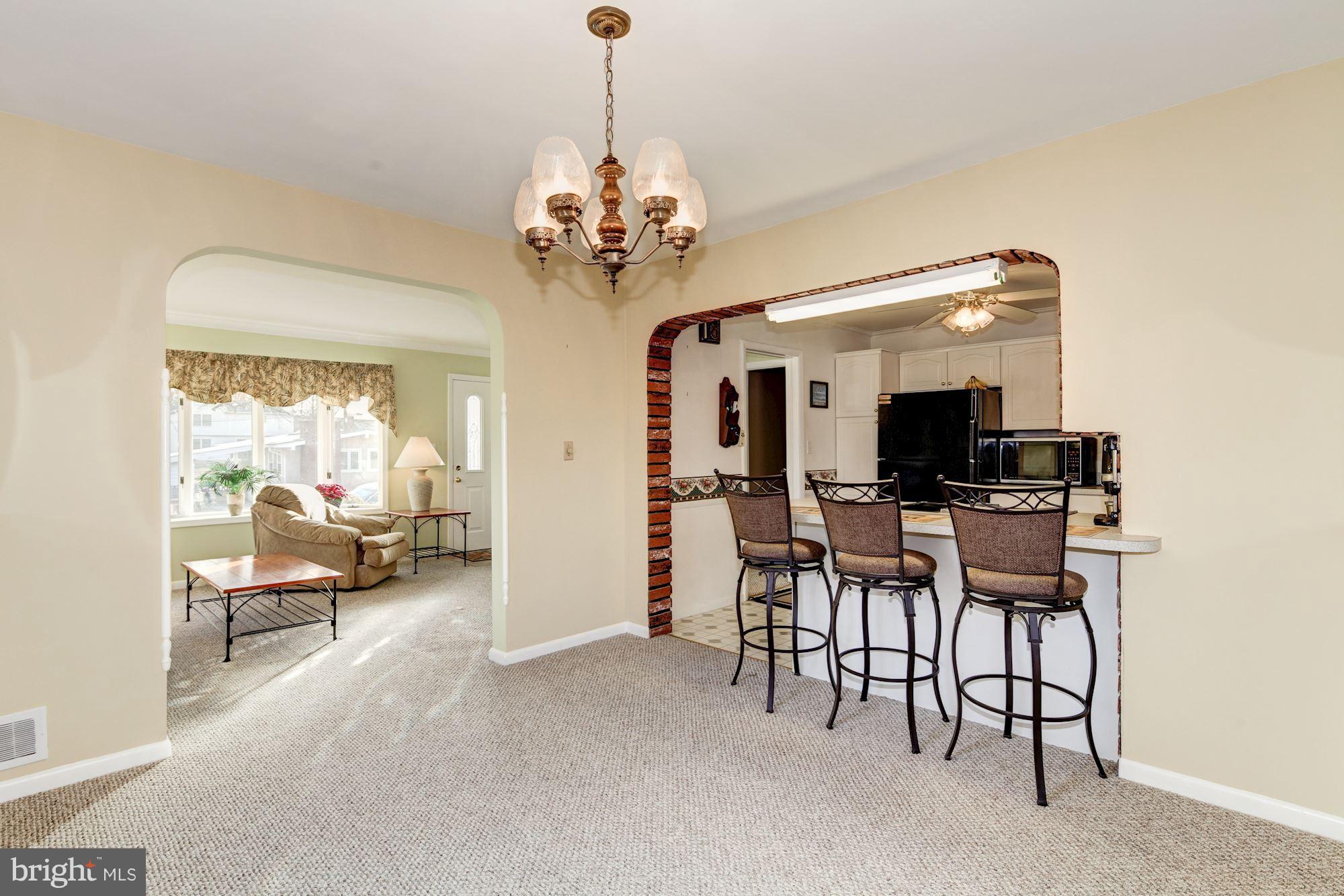 702 Edgewood Road Linthicum Heights, MD 21090 - Photo 5 of 21 a view of a dining room with furniture and a chandelier