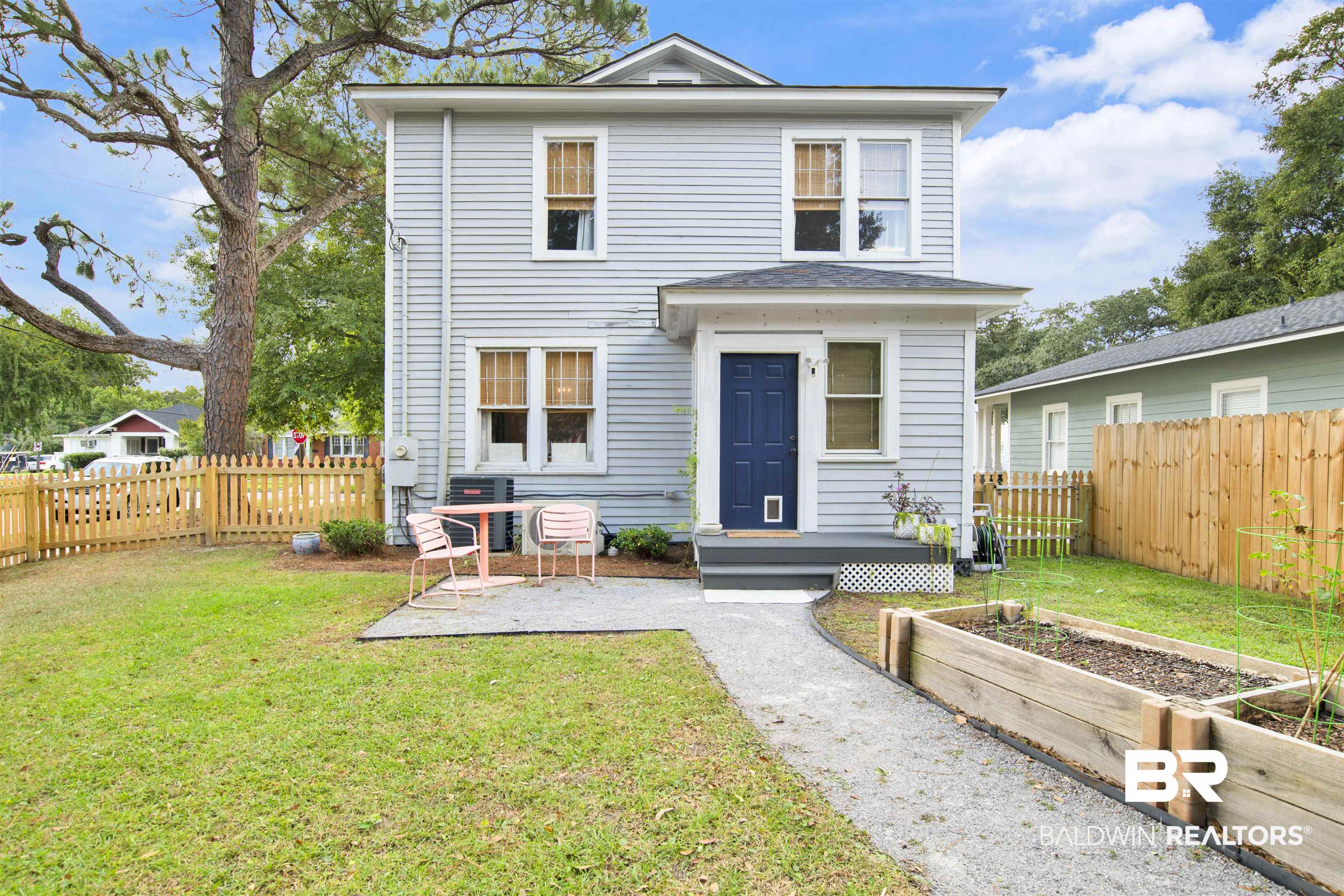 123 Macy Place Mobile, AL 36604 - Photo 32 of 35 View of front of home with a fenced backyard and a garden