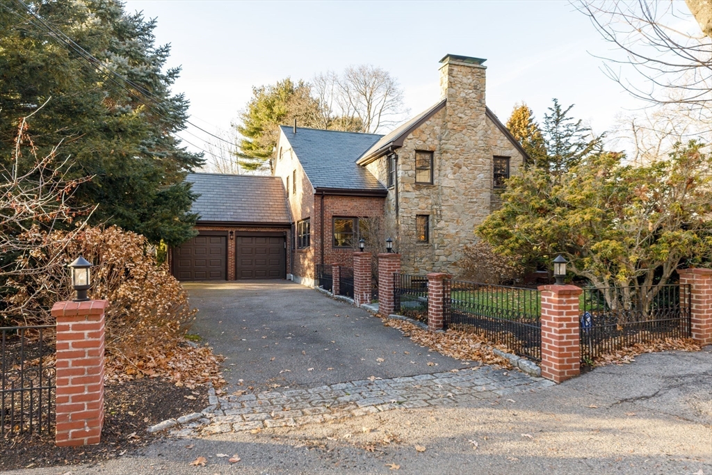 6 Risley Road Newton, MA 02465 - Photo 20 of 21 a front view of a house with a yard and garage
