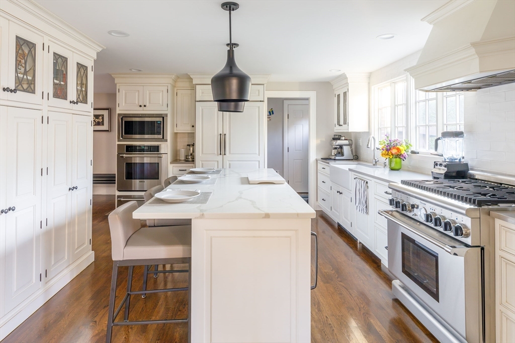 6 Risley Road Newton, MA 02465 - Photo 3 of 21 a kitchen with stainless steel appliances granite countertop a stove and a refrigerator