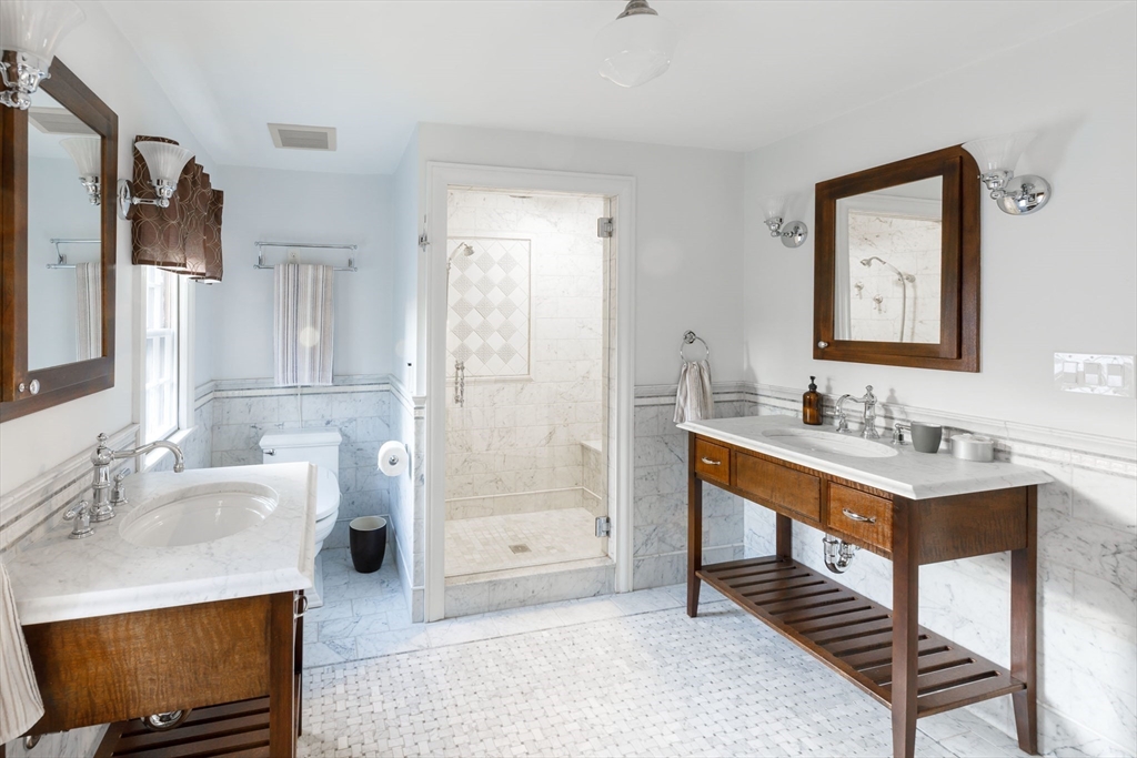 6 Risley Road Newton, MA 02465 - Photo 8 of 21 a bathroom with a sink a toilet a mirror and shower