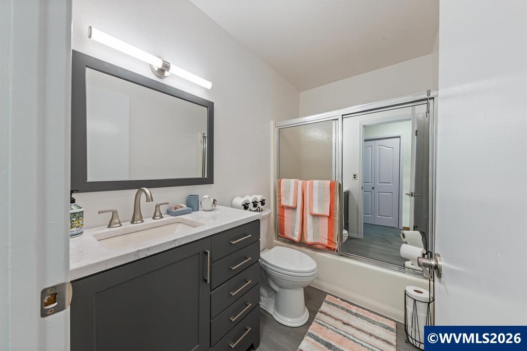 6100 Teal Creek Road Dallas, OR 97338 - Photo 19 of 41 a bathroom with a toilet sink double vanity and mirror