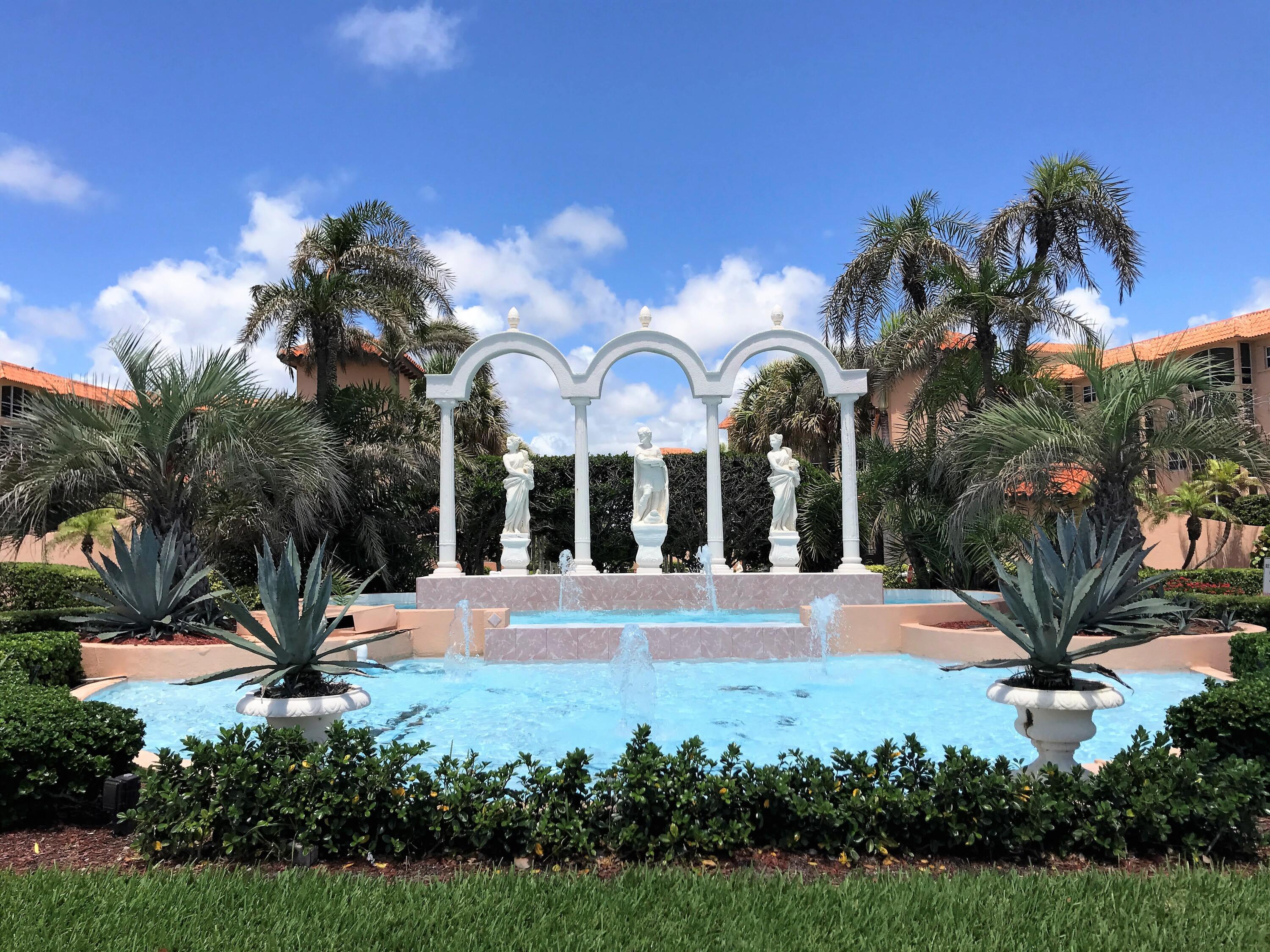 2871 North Ocean Boulevard, Unit V443 Boca Raton, FL 33431 - Photo 34 of 49 a view of fountain in front of a house with palm trees