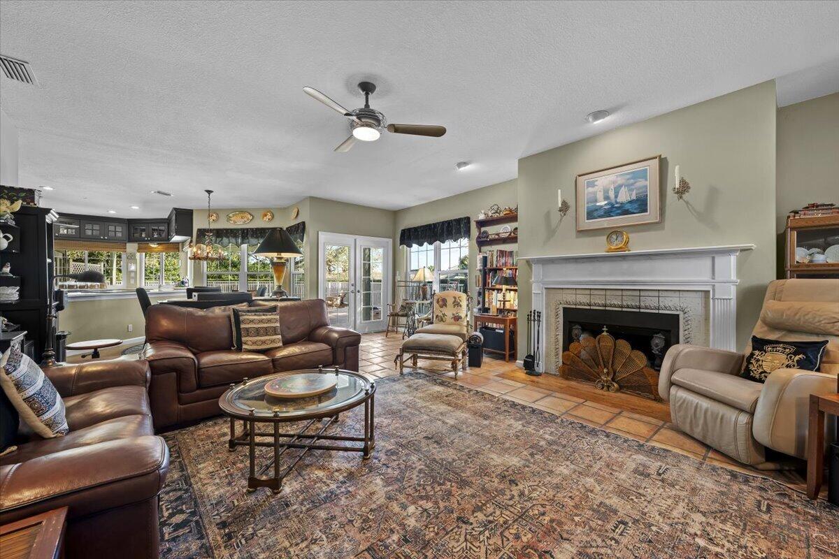7 Alnwick Road Palm Beach Gardens, FL 33418 - Photo 12 of 47 a living room with furniture and a fireplace