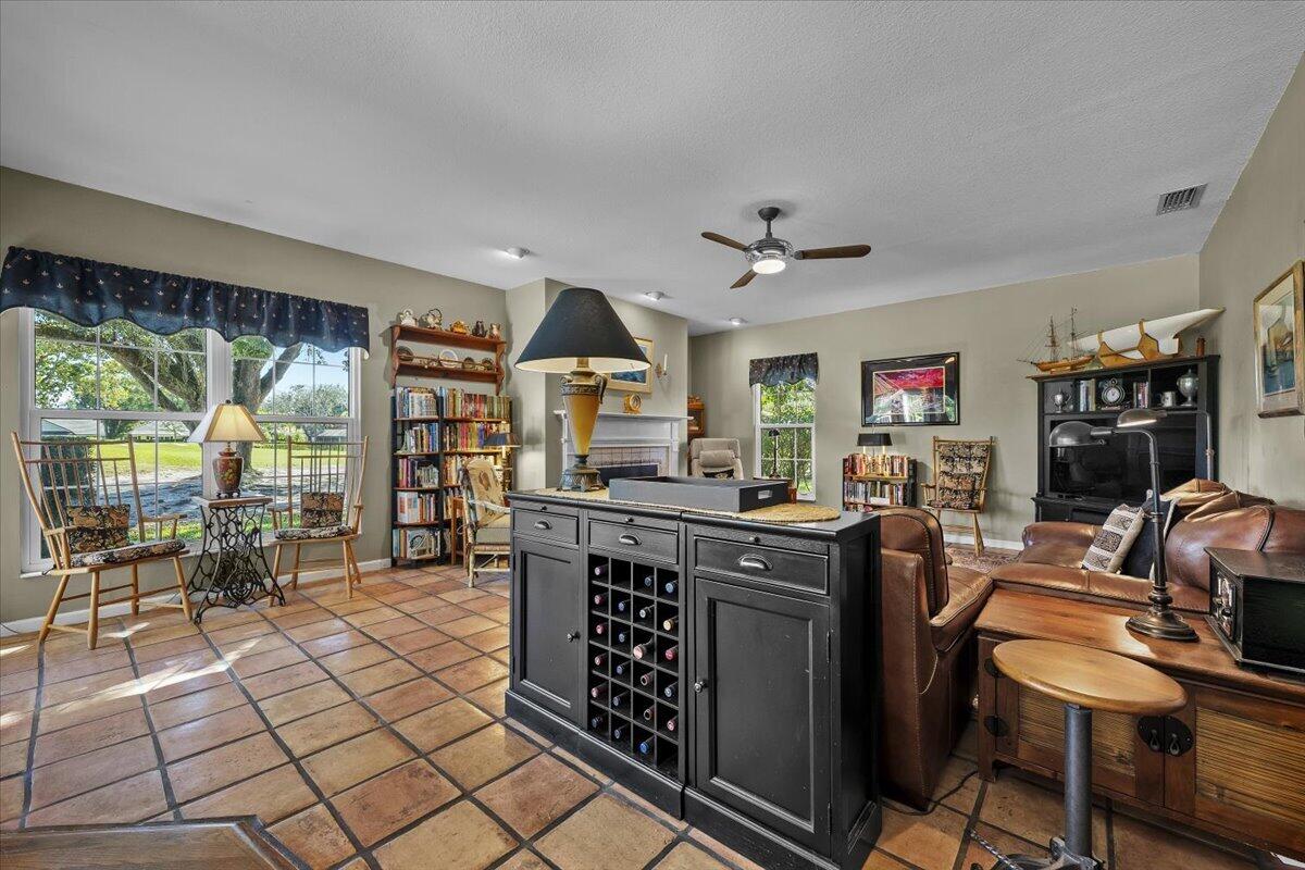 7 Alnwick Road Palm Beach Gardens, FL 33418 - Photo 13 of 47 a view of a workspace with furniture and a livingroom
