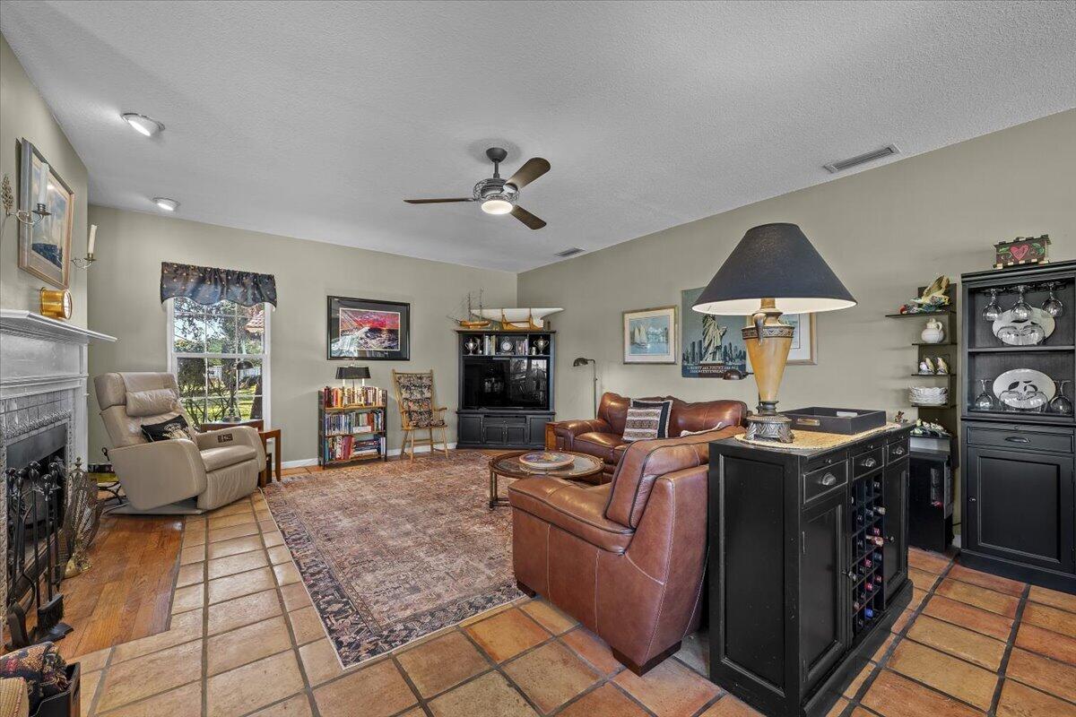 7 Alnwick Road Palm Beach Gardens, FL 33418 - Photo 14 of 47 a living room with fireplace furniture and a flat screen tv