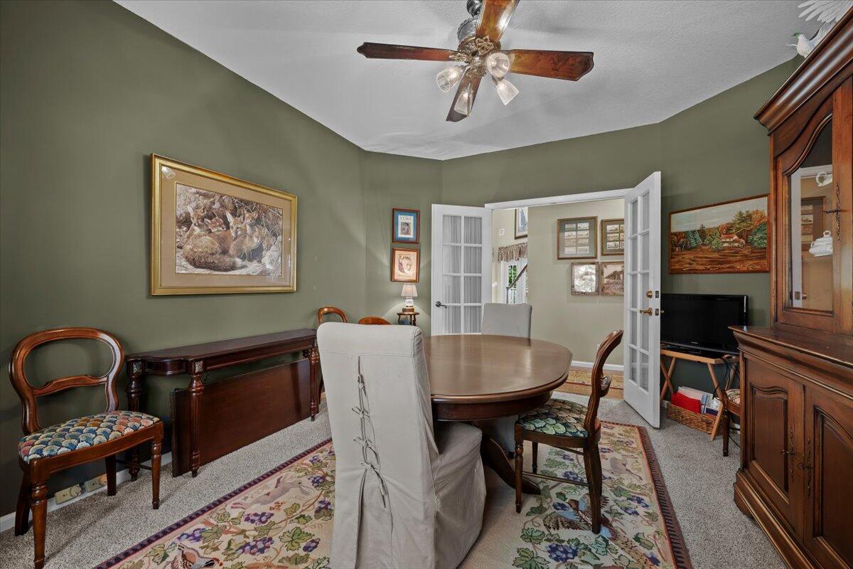 7 Alnwick Road Palm Beach Gardens, FL 33418 - Photo 15 of 47 a view of a dining room with furniture a rug and wooden floor