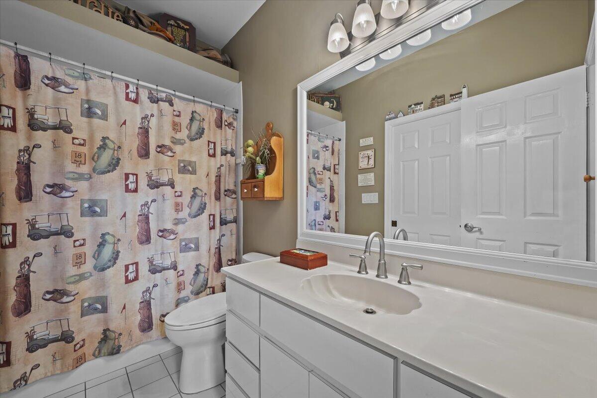 7 Alnwick Road Palm Beach Gardens, FL 33418 - Photo 17 of 47 a bathroom with a sink a toilet and shower