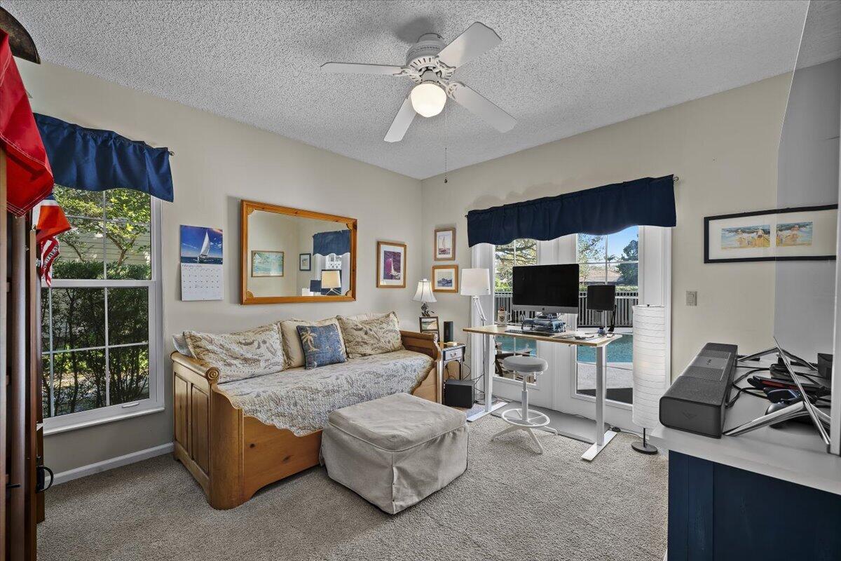7 Alnwick Road Palm Beach Gardens, FL 33418 - Photo 18 of 47 a living room with furniture a flat screen tv and a fireplace