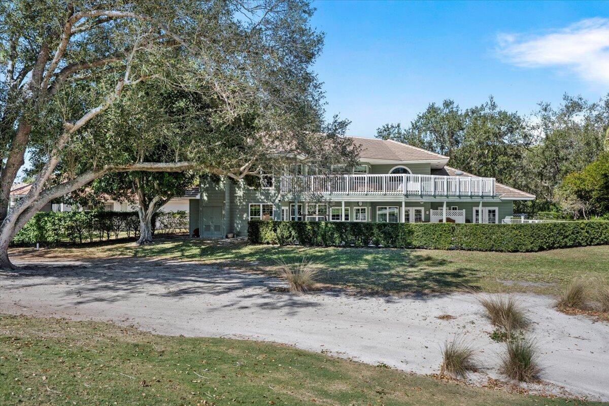 7 Alnwick Road Palm Beach Gardens, FL 33418 - Photo 2 of 47 a front view of a house with a yard