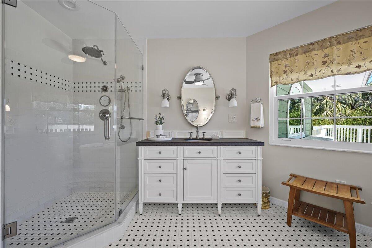 7 Alnwick Road Palm Beach Gardens, FL 33418 - Photo 24 of 47 a bathroom with a sink a mirror and a shower