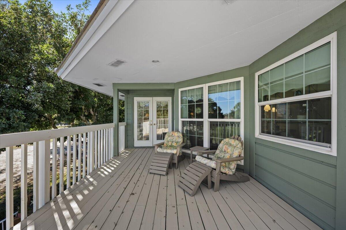 7 Alnwick Road Palm Beach Gardens, FL 33418 - Photo 27 of 47 a view of deck with chairs and wooden floor