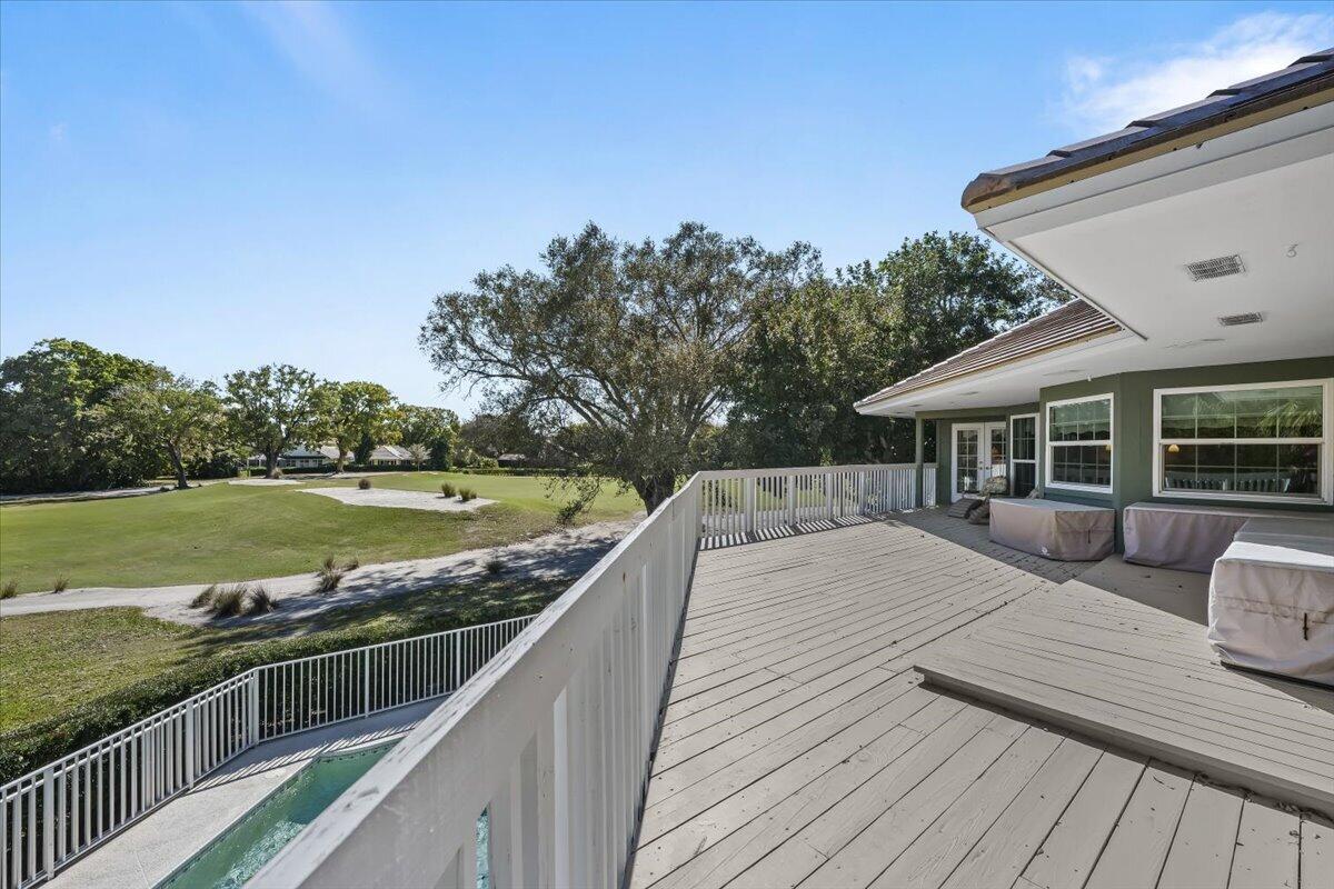 7 Alnwick Road Palm Beach Gardens, FL 33418 - Photo 28 of 47 a view of a wooden deck and a yard